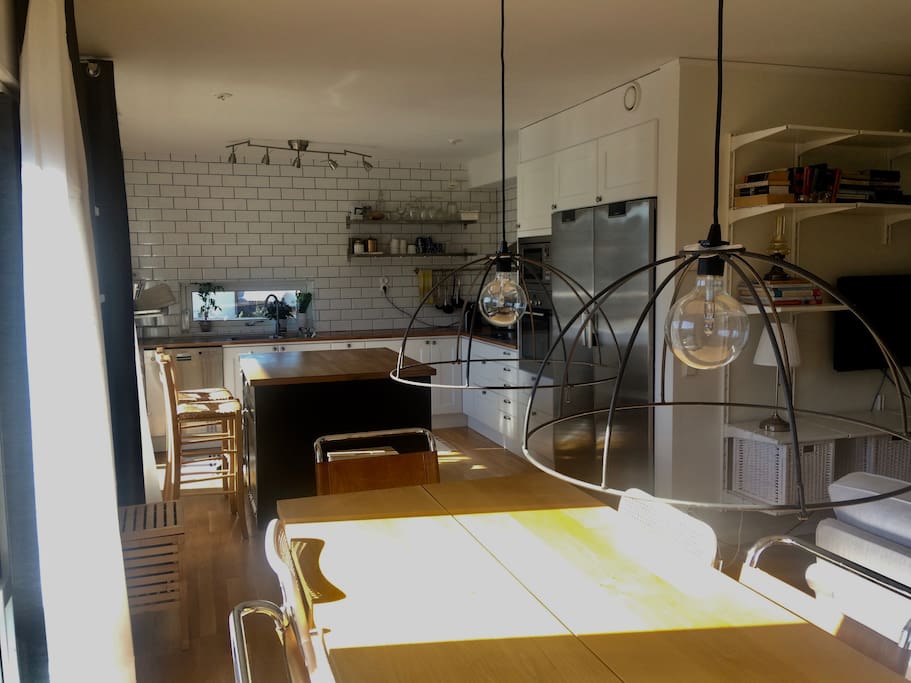 Kitchen diner which comfortably seats 8 people and seats for another 4 around kitchen island.