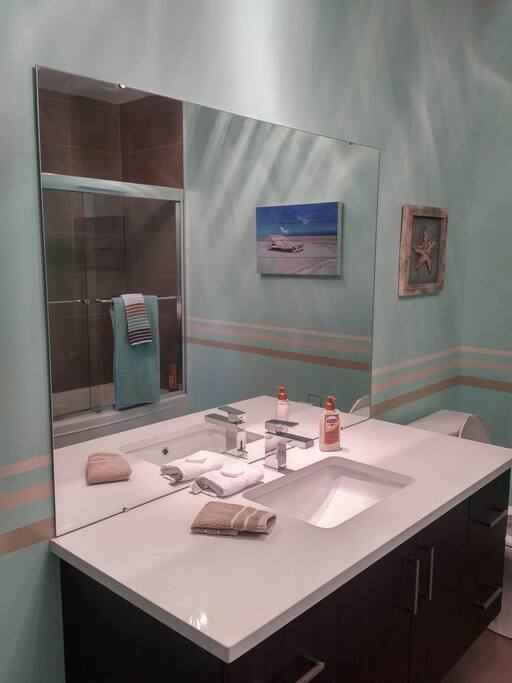Spacious modern bathroom. Laundry facilities. Iron & ironing board.