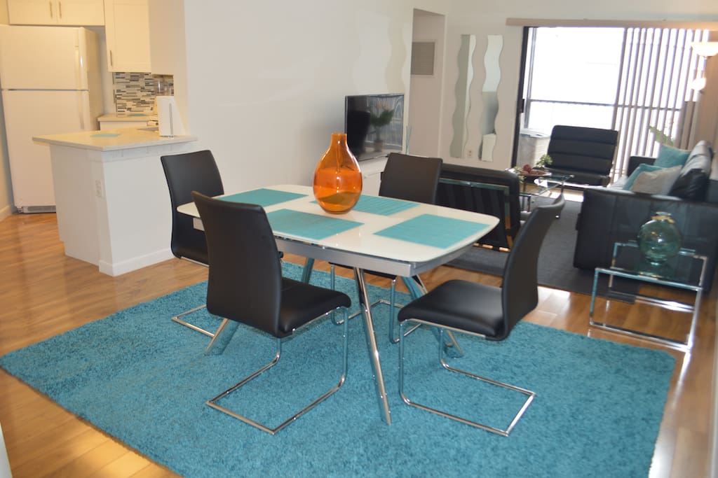 Modern living room and dinning room with flat screen TV and comfortable seating