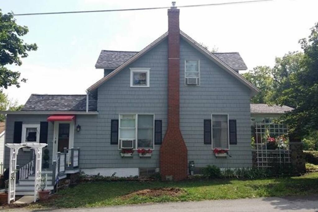 Charming cedar sided home with full basement, 3 bedrooms and awesome front porch.