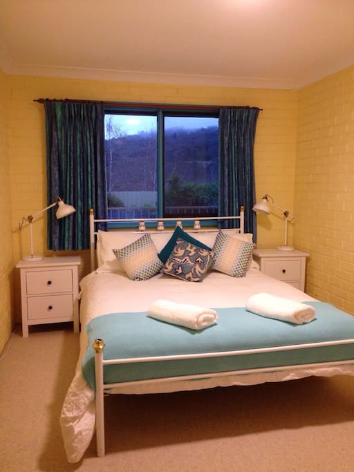Comfortable bed in a room with a view.