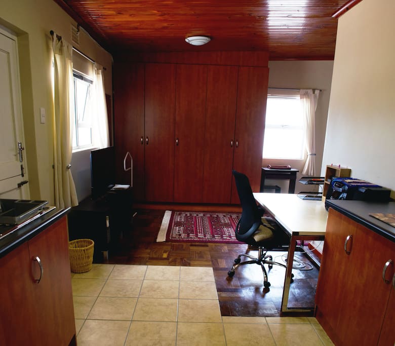 View of open plan area, wardrobe and 40 inch Smart TV.