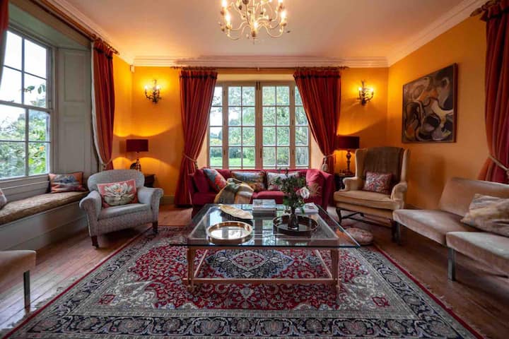 Extremely comfortable and large living room, featuring beautiful sash windows overlooking the countryside and the Manor's walled garden + a wood-burning stove. 