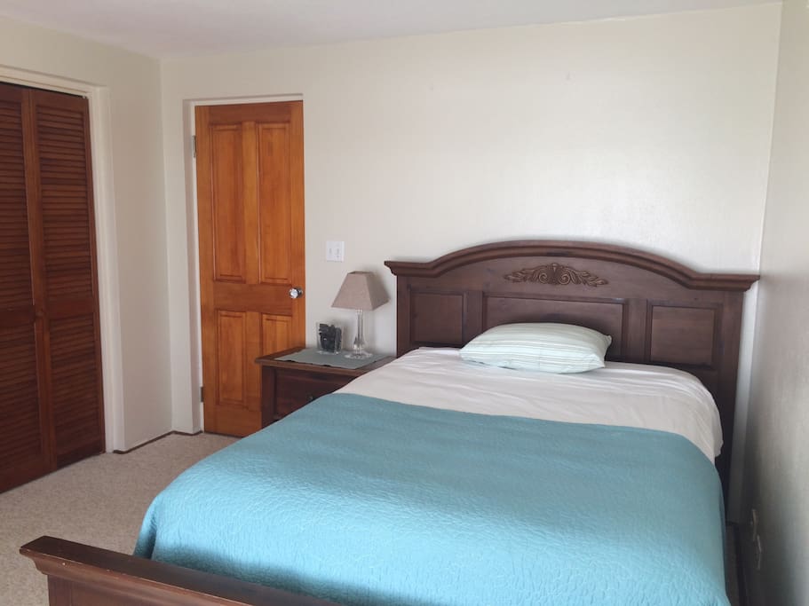Double bed with closet for luggage storage to a few hangers provided as well.