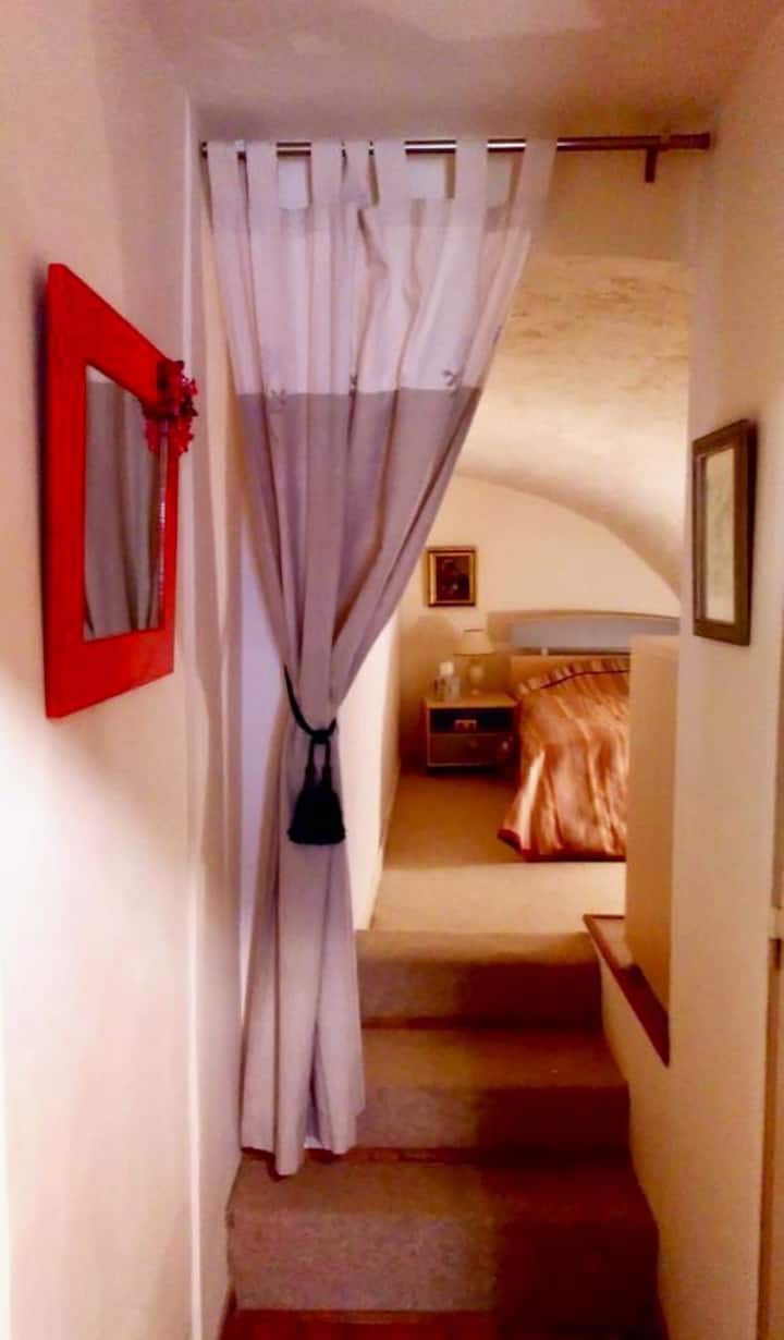 Cozy separate bedroom with a single bed tucked into a grotto. 