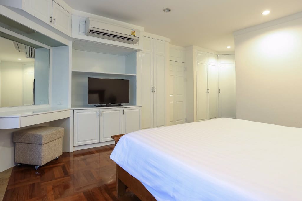 Master bedroom with king sized bed and private bathroom