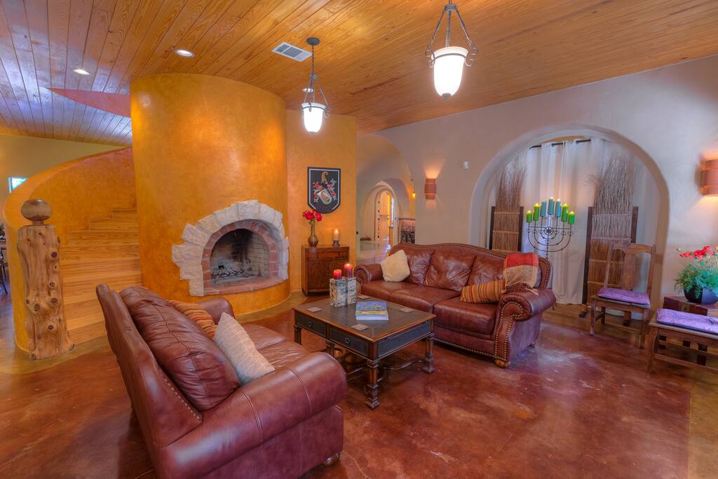 Entry living area with leather couches and wood burning fireplace