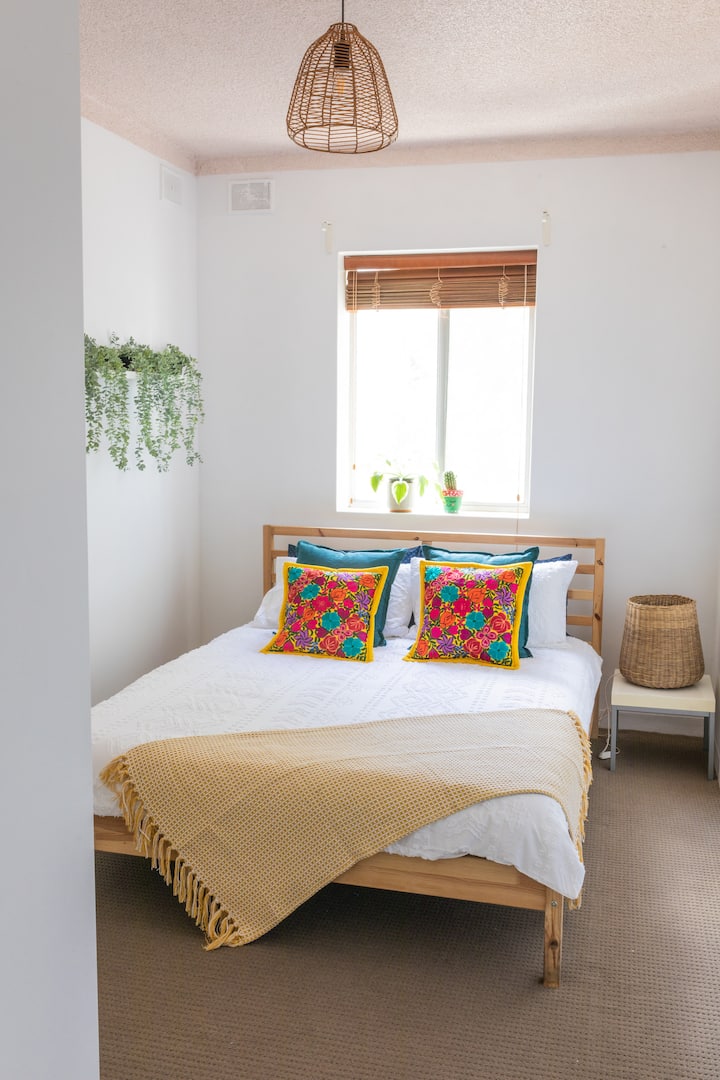 Mexico-inspired second bedroom with timber double bed