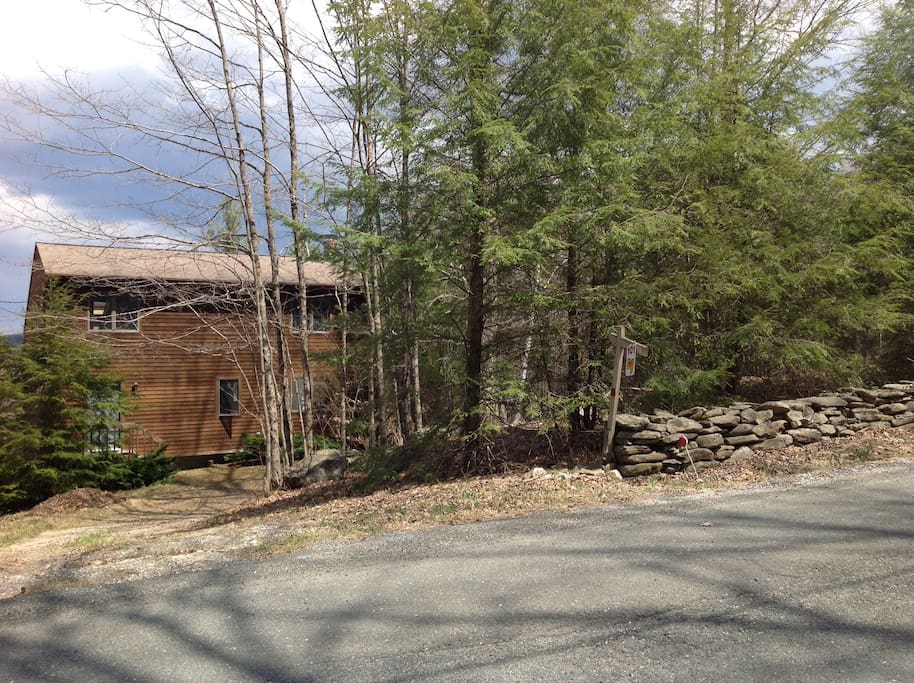 House and stonewall on dead-end road.