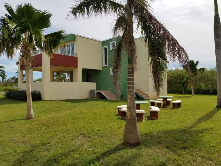 nice backyard with 2 concrete tables for out door dining