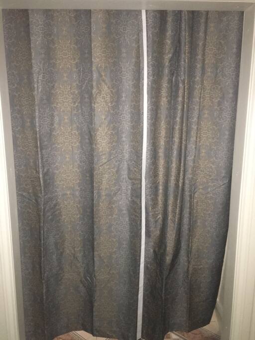 It doesn't have a door but the curtains do give you your own privacy