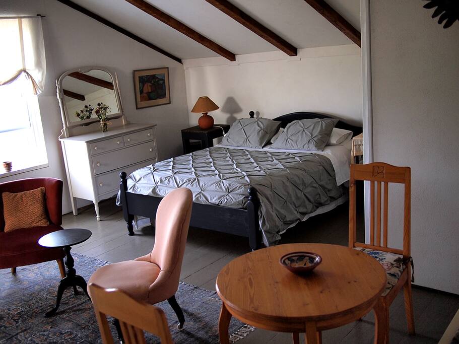 Our spacious 'East Room' features exposed pit-sawn rafters, a super-comfy queen bed, with authentic Swedish furnishings...