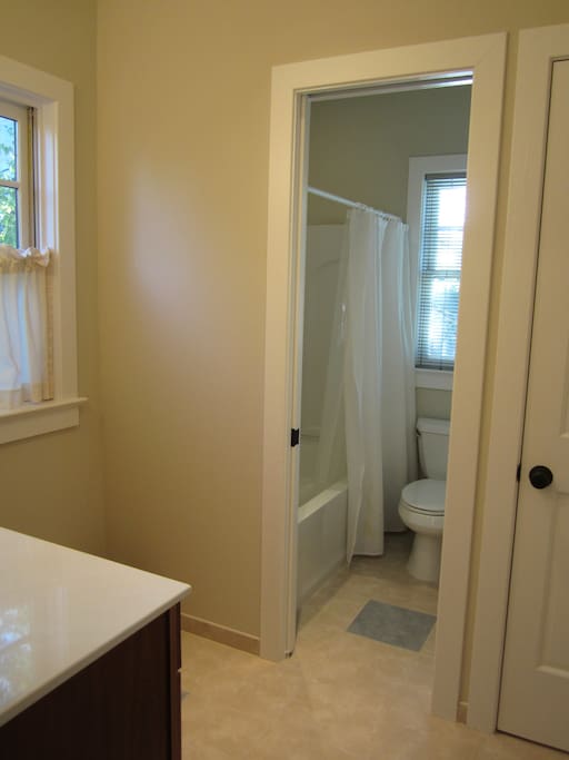 Tub & toilet area of shared bath.