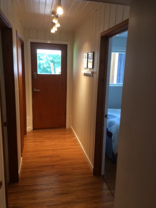 private entrance with large closet on left, living area to left, and bedroom on right