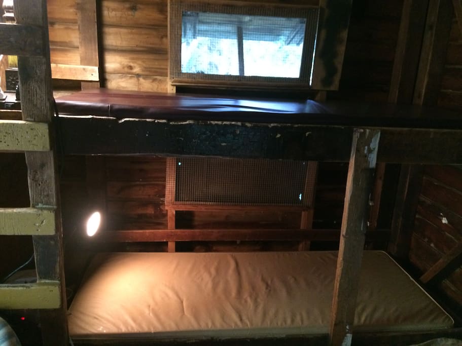 It used to be a cabin at a kids' camp, thus the bunks. Comfortable rubber covered mattresses.