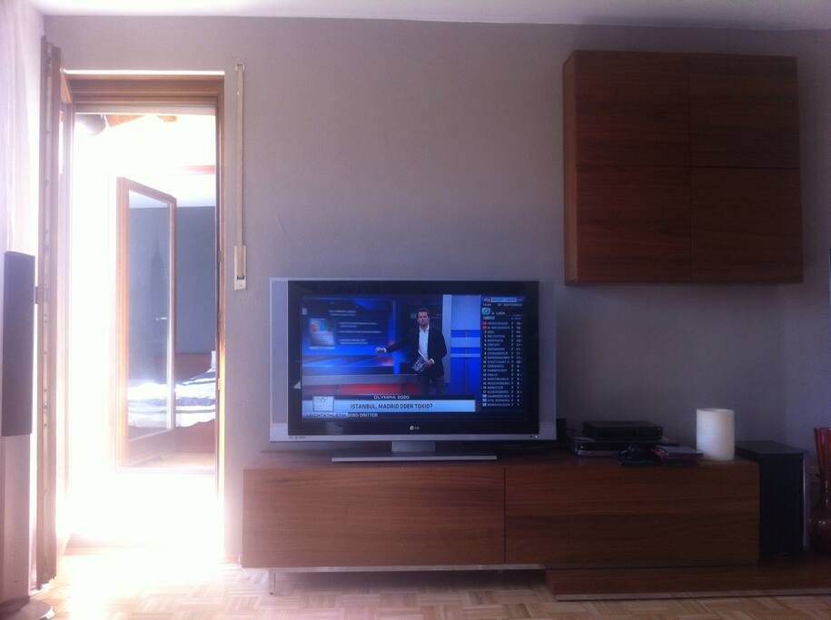 living room with balcony and a view in the bedroom