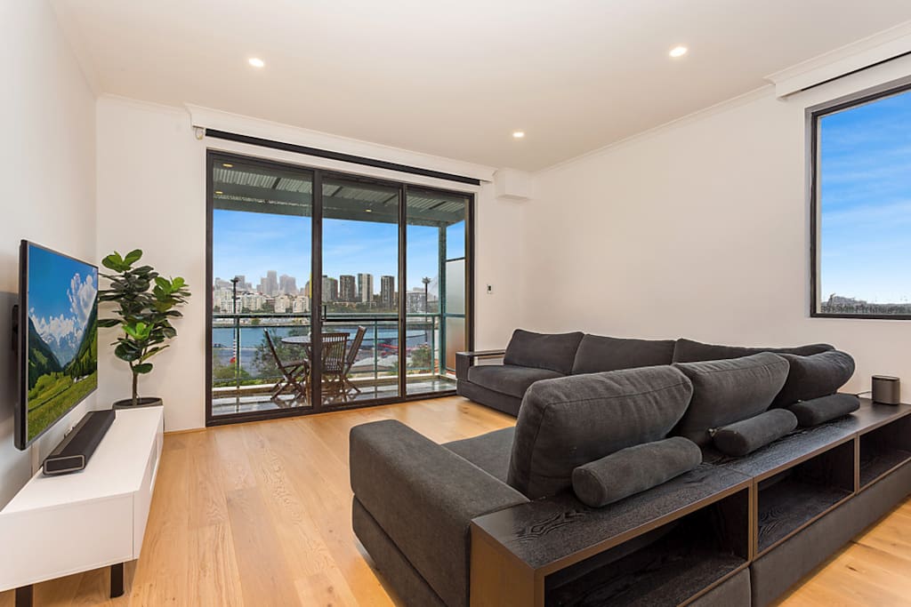 Lounge Room - large 6 seater lounge - 60" UHD smart TV - Foxtel - Expansive City & Harbour Views - Sonos Playbar x2 Play1 Speakers for surround sound.