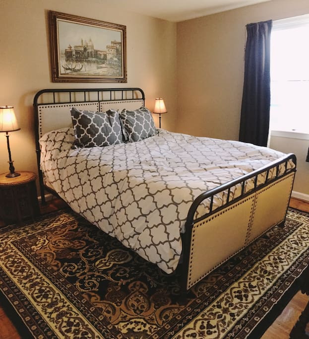 Master bedroom with nightstands and reading lamps.