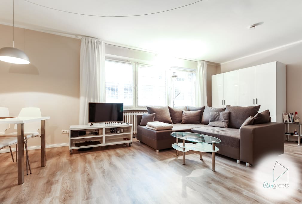 Relax on the large sofa and watch a good movie on TV.