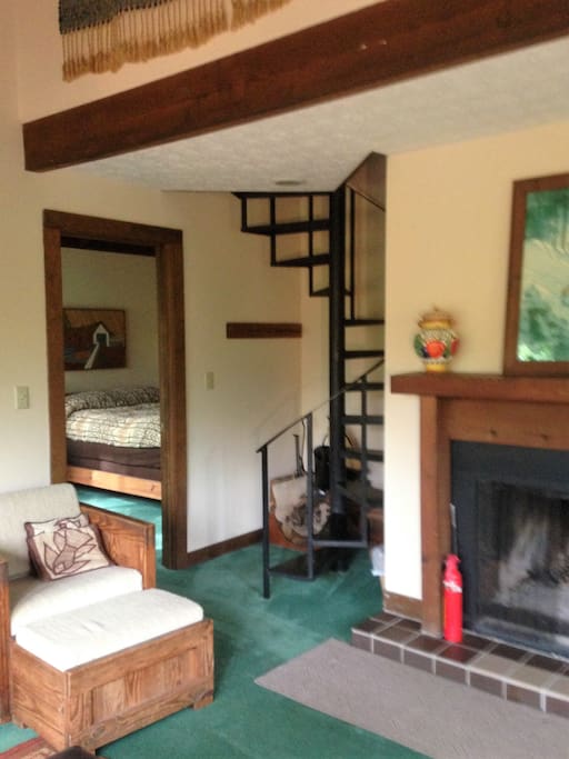 wood burning fireplace & stairs to loft