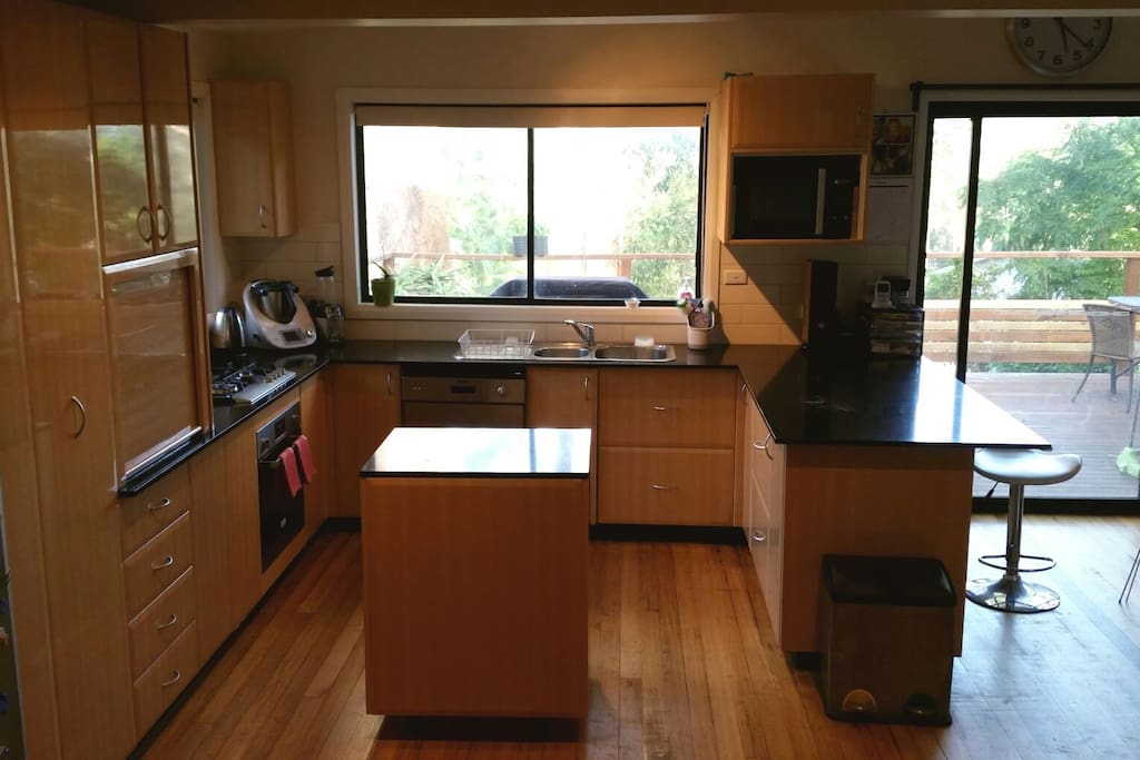 Open plan kitchen over looking deck and garden