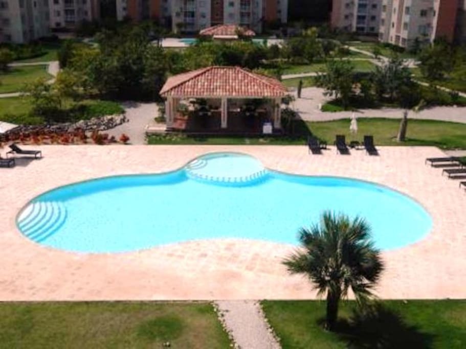 Pool area and Gazebo with bathrooms, tables, chairs, loungers