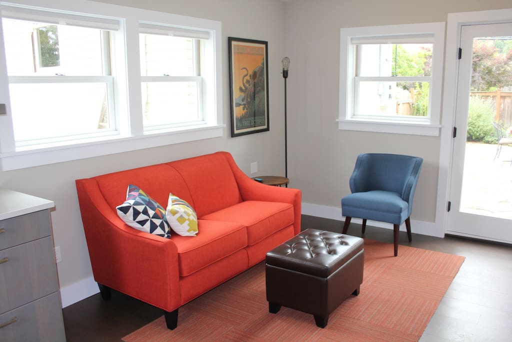 The living space bursts with natural light and cheerful color.