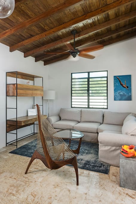 Living area with sofa bed, desk and funky chair