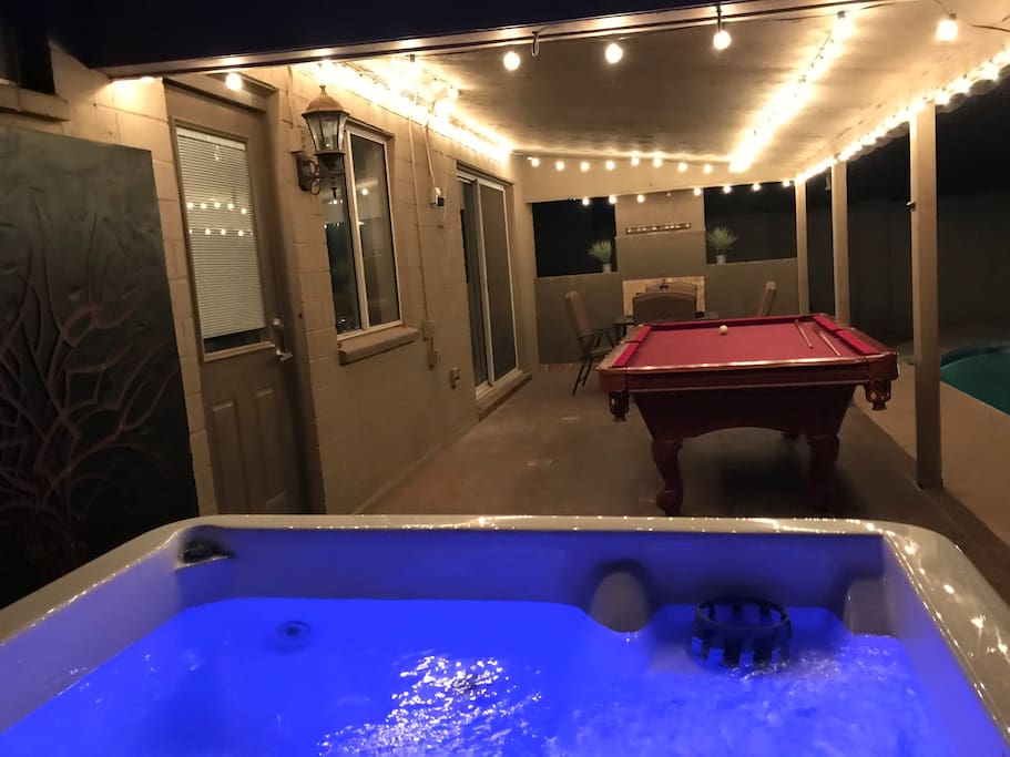 Hot tub with jets, pool table, dart board, bags (aka corn hole) and lounge area