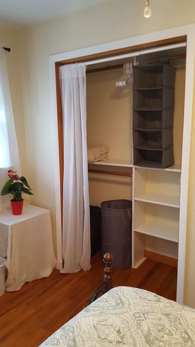 Laptop stand and spacious closet with hangers and organizer. Extra blankets, comforter, and laundry hamper.