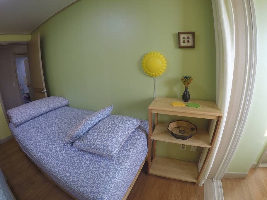 A lamp and shelving space with outlets for each bed.