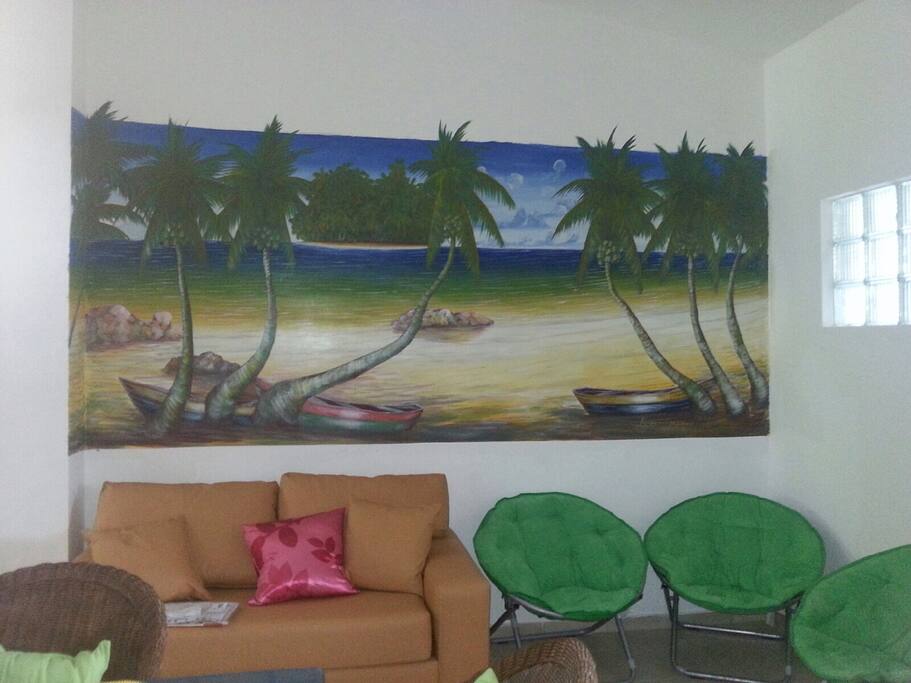 Hand painted mural in living area with additional couch/bed