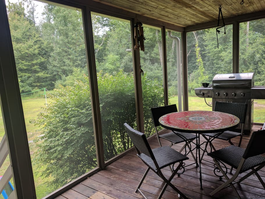 Other side of screened in porch for dining and grilling