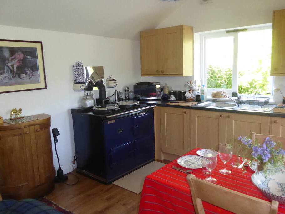 Kitchen and dining room. There is an AGA which makes it very warm in written