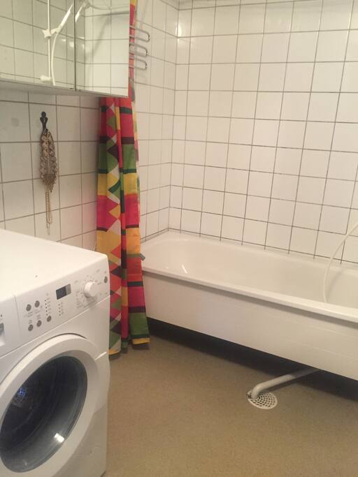The bathroom is next to the bedroom with the big bed