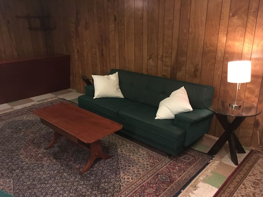 Couch, throw pillows, coffee table, side tables and lamp.