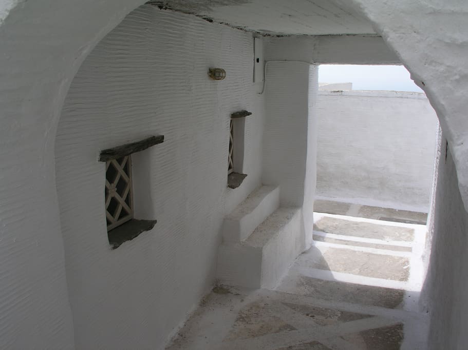 Pathway leading to the studio. Bedroom and bathroom windows on the left.