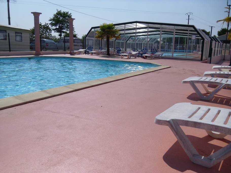 Outdoor swimming pool looking onto indoor swimming pool