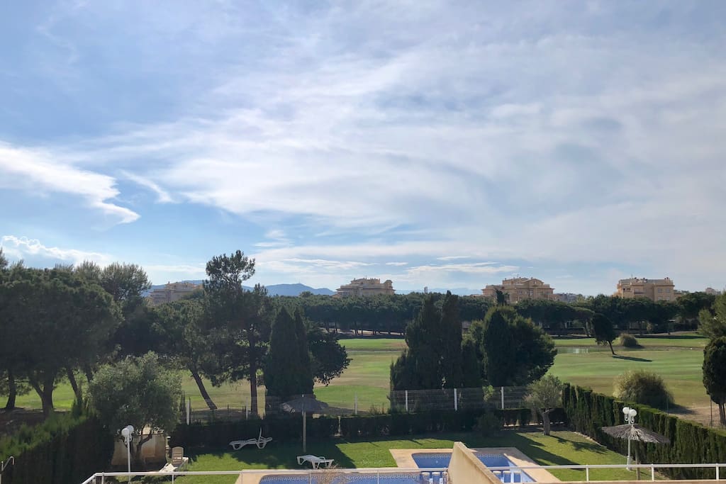 View of golf course from glass balcony
