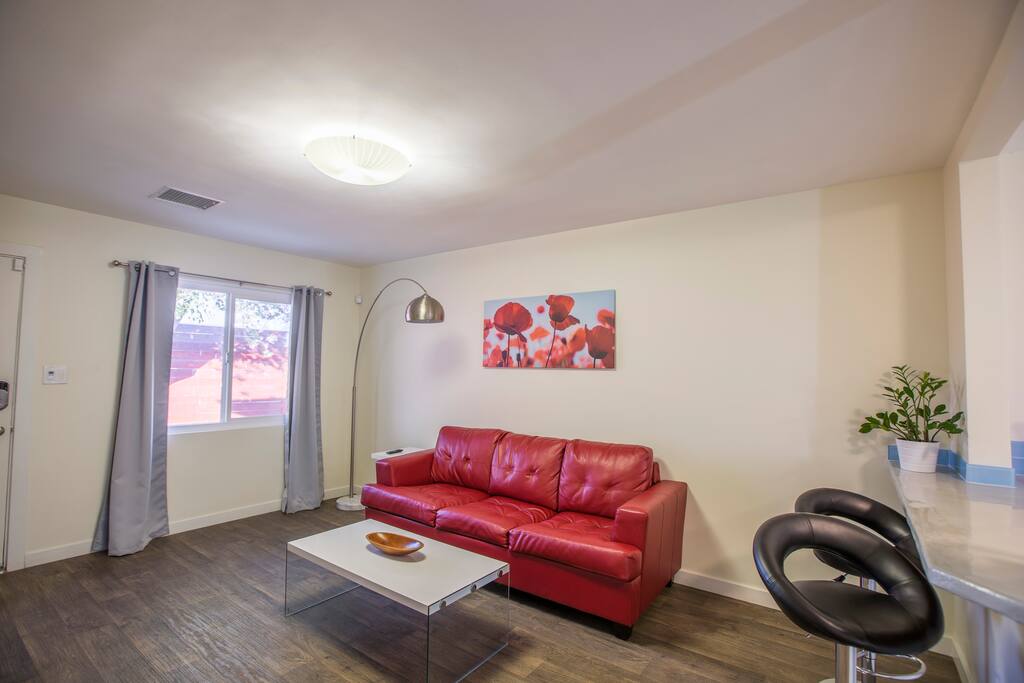 Spacious living room with modern furniture and new tile throughout the bungalow. This sofa turns into a spacious queen size bed to sleep up to 4 people in the bungalow very comfortably