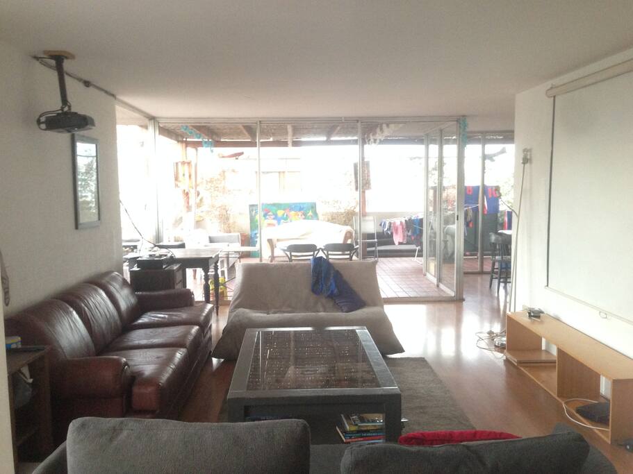 The living with three bigs sofa and a video projector