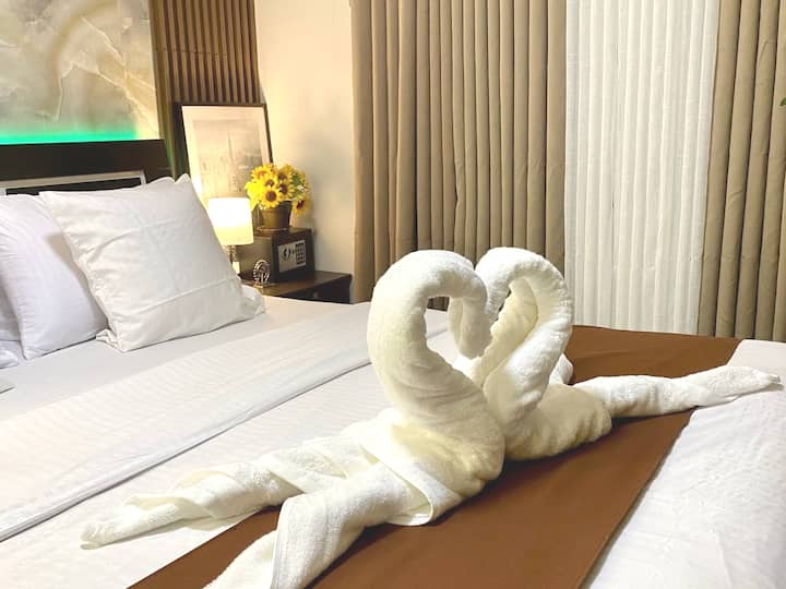 Queen size bed fitted with two (2) expanded pillows, two (2) brushed fiber pillows, two (2) throw pillows, bed runner and fluffy duvet. Headboard comes with LED strip light for added drama.