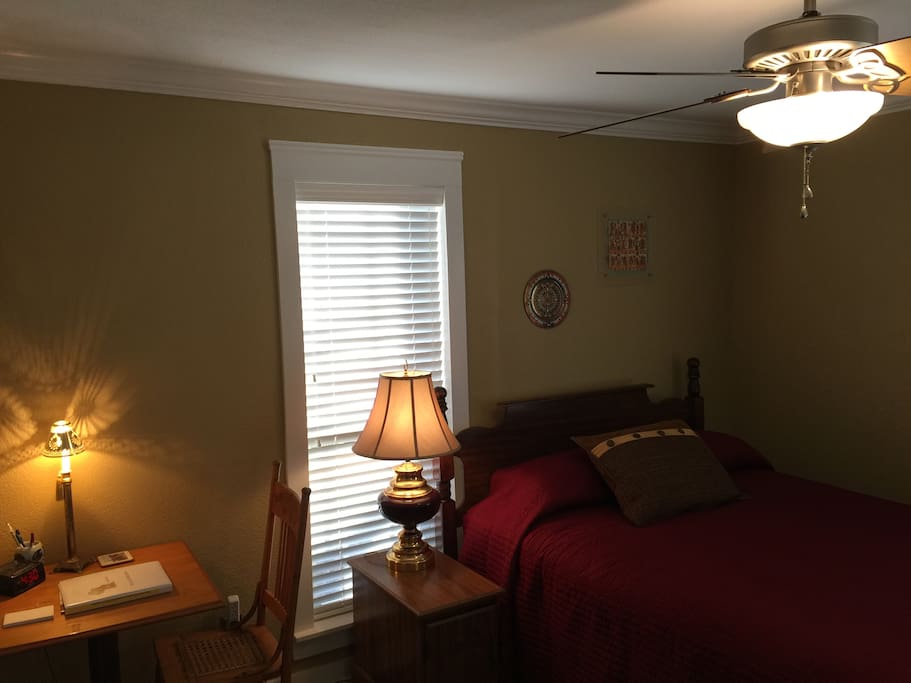 The en suite room with queen-sized bed is a corner room with plenty of light. The bath is through the door.