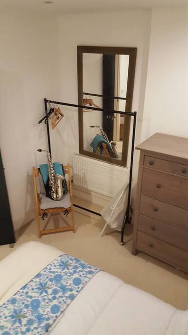 Bedroom storage, with drawers, rail, chair and lots of spare bedding and towels