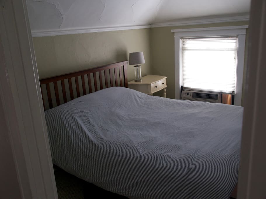 A queen size bed, walk in closet, and underbed storage make up this cozy bedroom.