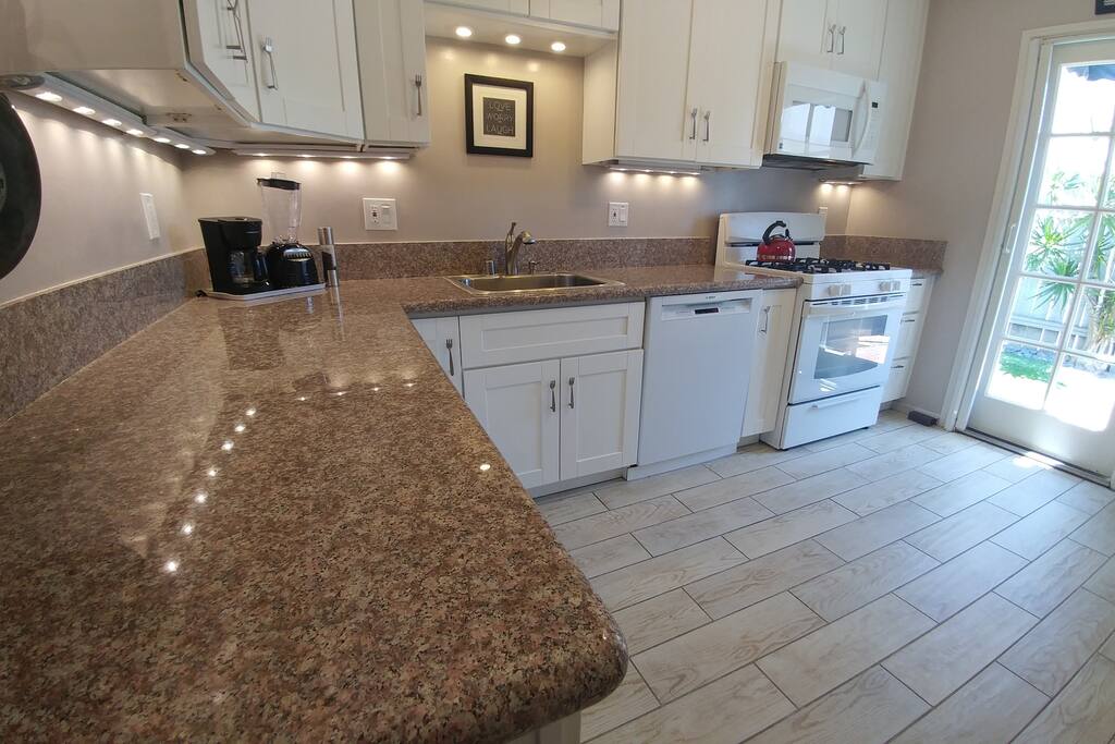 Kitchen with granite counter tops an glass door to your private back yard!