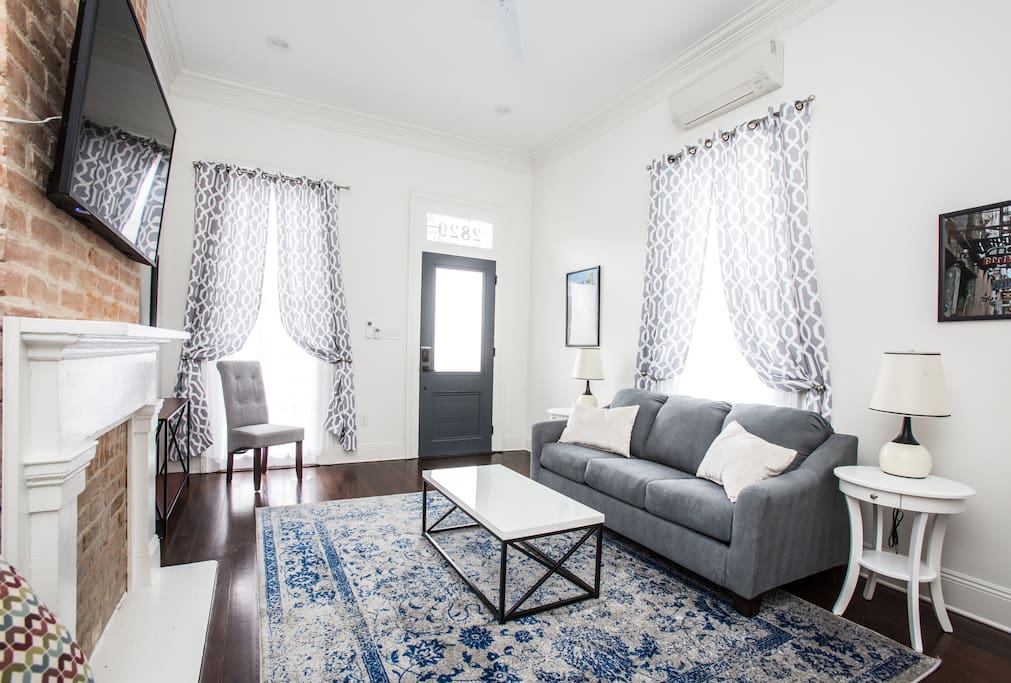 Living room. Queen sleeper sofa. 55" wifi tv. Looking at front door.