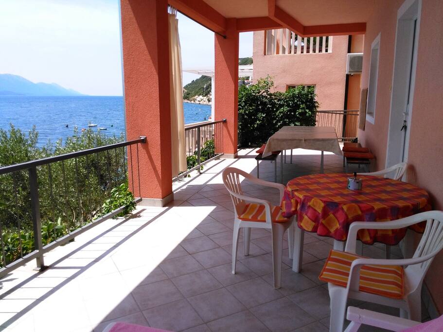 Big terrace in front of the apartment with seafront view