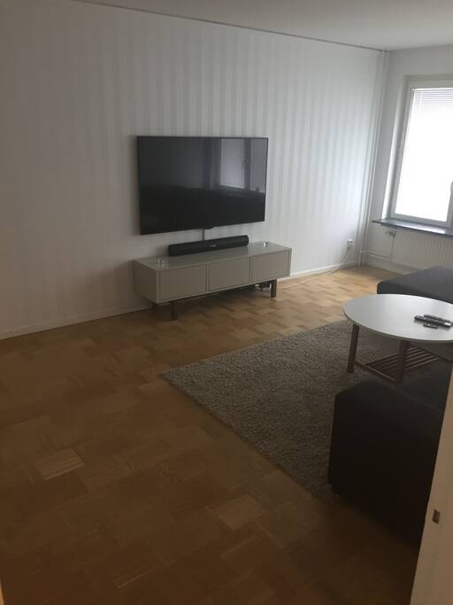 Living room 65" cable TV with Playstation 4 and big sofa :)