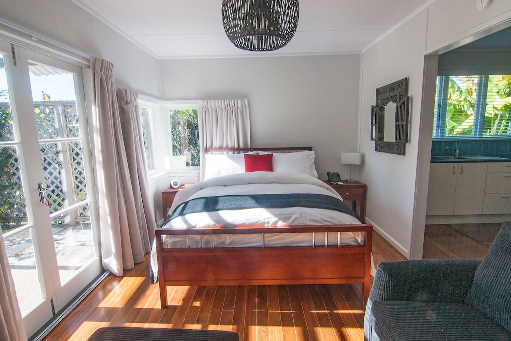 French doors open onto the sunny, north facing outdoor lounge, and into the gardens.